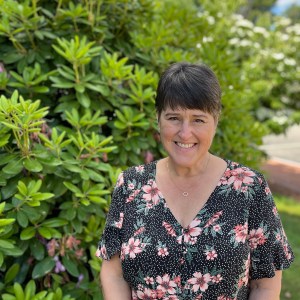 Joan smiling in front of the library